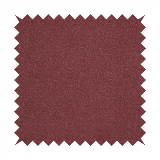 A suede fabric in a deep, muted maroon or burgundy colour.