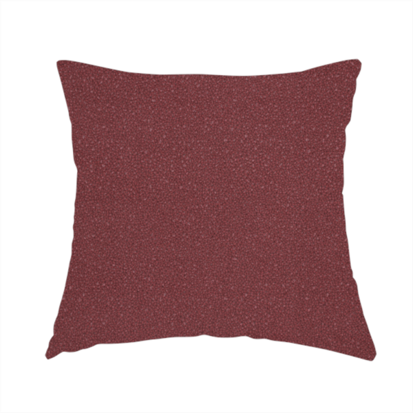 The fabric used to create this handmade cushion is a suede fabric in a deep, muted maroon or burgundy colour.