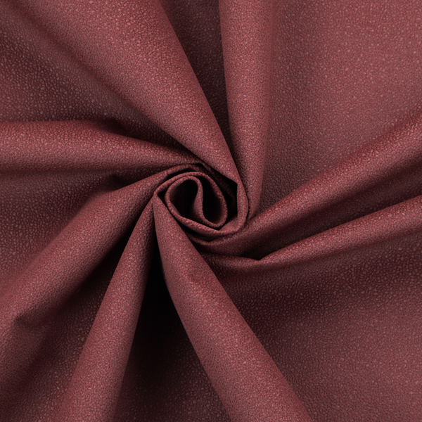 A suede fabric in a deep, muted maroon or burgundy colour.
