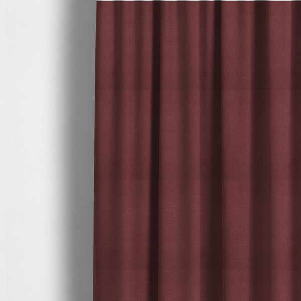 The fabric used to create these made-to-measure curtains is a suede fabric in a deep, muted maroon or burgundy colour.