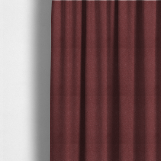 The fabric used to create these made-to-measure curtains is a suede fabric in a deep, muted maroon or burgundy colour.