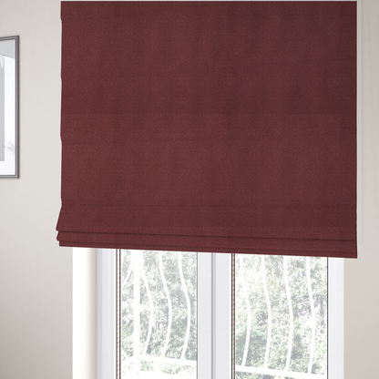 The fabric used to create these Roman blinds is a suede fabric in a deep, muted maroon or burgundy colour.