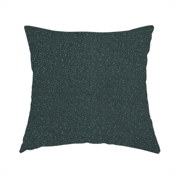 The fabric used to create this handmade cushion is a Merida Suede upholstery fabric in a deep, dark teal or charcoal green colour.