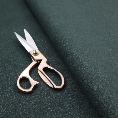 A Merida Suede upholstery fabric in a deep, dark teal or charcoal green colour.