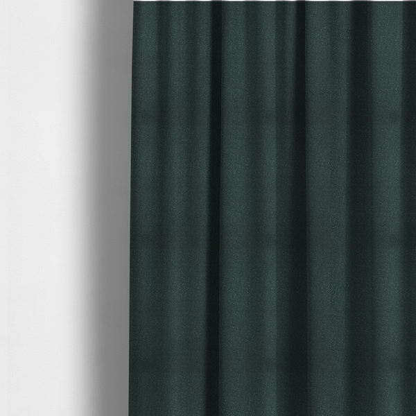 The fabric used to create these made-to-measure curtains is a Merida Suede upholstery fabric in a deep, dark teal or charcoal green colour.