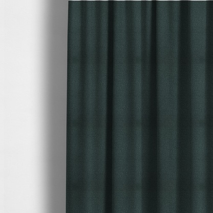 The fabric used to create these made-to-measure curtains is a Merida Suede upholstery fabric in a deep, dark teal or charcoal green colour.