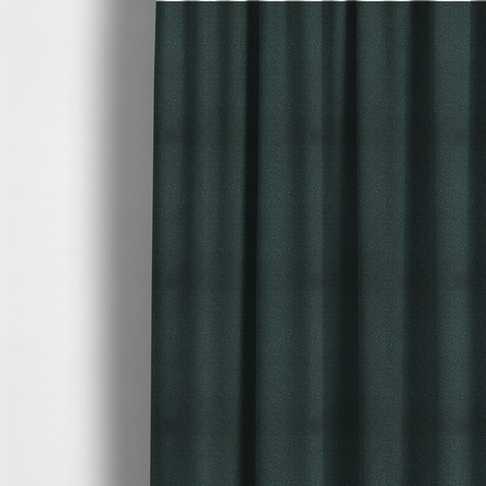 The fabric used to create these made-to-measure curtains is a Merida Suede upholstery fabric in a deep, dark teal or charcoal green colour.