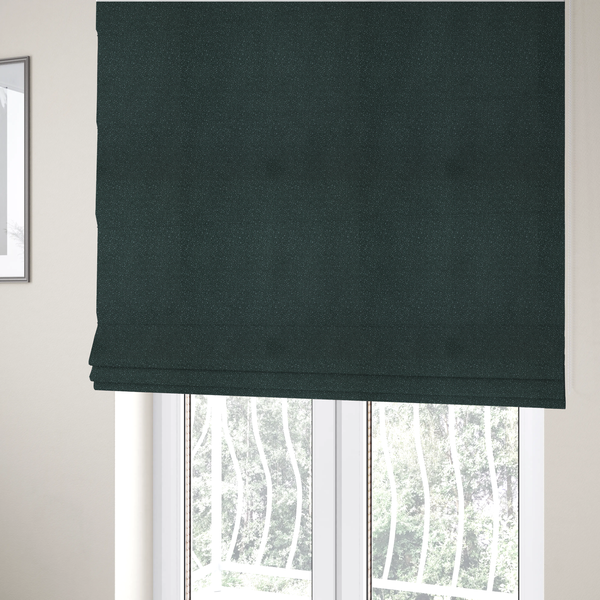The fabric used to create these Roman blinds is a Merida Suede upholstery fabric in a deep, dark teal or charcoal green colour.