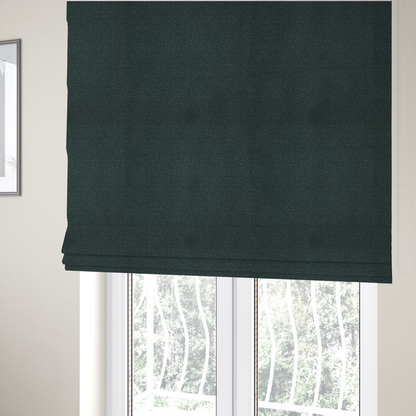 The fabric used to create these Roman blinds is a Merida Suede upholstery fabric in a deep, dark teal or charcoal green colour.
