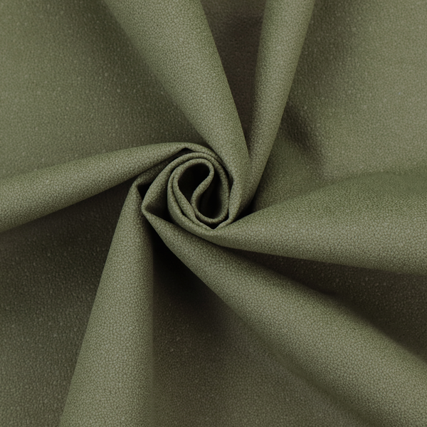 A Merida Suede upholstery fabric in a muted olive green or sage colour.
