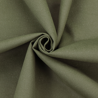 A Merida Suede upholstery fabric in a muted olive green or sage colour.