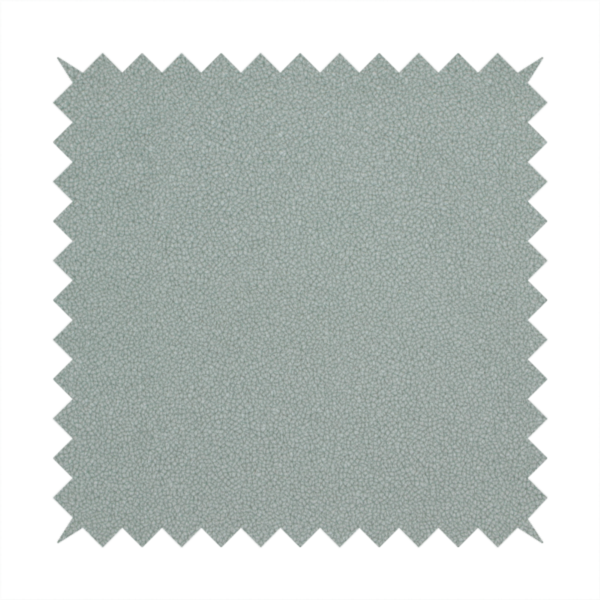 A Merida Suede upholstery fabric in a light sage or pale eucalyptus green colour.