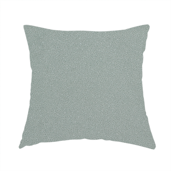 The fabric used to create this handmade cushion is a Merida Suede upholstery fabric in a light sage or pale eucalyptus green colour.