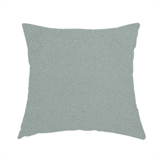 The fabric used to create this handmade cushion is a Merida Suede upholstery fabric in a light sage or pale eucalyptus green colour.