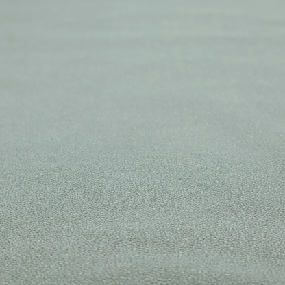 A Merida Suede upholstery fabric in a light sage or pale eucalyptus green colour.