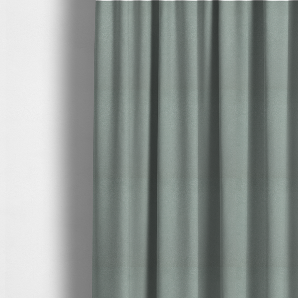 The fabric used to create these made-to-measure curtains is a Merida Suede upholstery fabric in a light sage or pale eucalyptus green colour.