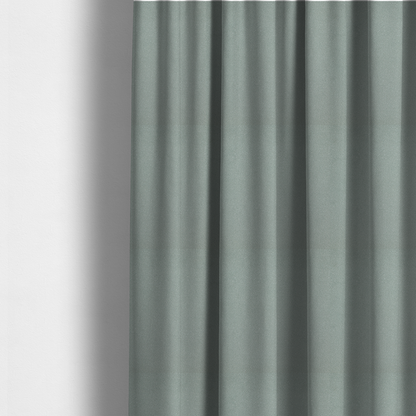 The fabric used to create these made-to-measure curtains is a Merida Suede upholstery fabric in a light sage or pale eucalyptus green colour.