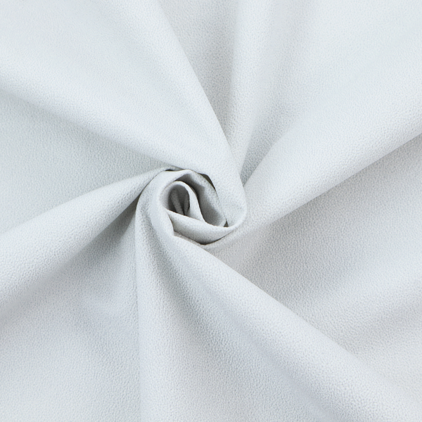 A Merida Suede upholstery fabric in a very pale, off white colour.