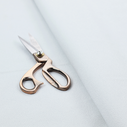 A Merida Suede upholstery fabric in a very pale, off white colour.