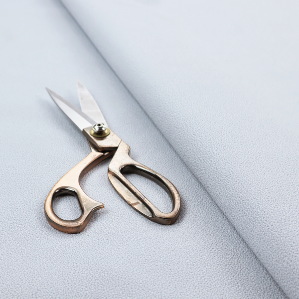 A Merida Suede upholstery fabric in a light silver colour.