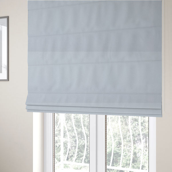 The fabric used to create these Roman blinds is a Merida Suede upholstery fabric in a light silver colour.