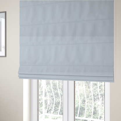 The fabric used to create these Roman blinds is a Merida Suede upholstery fabric in a light silver colour.
