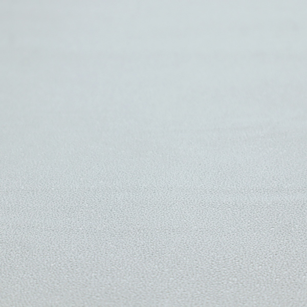 A Merida Suede upholstery fabric in a light grey colour.
