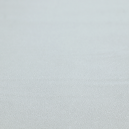 A Merida Suede upholstery fabric in a light grey colour.
