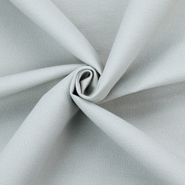 A Merida Suede upholstery fabric in a light grey colour.