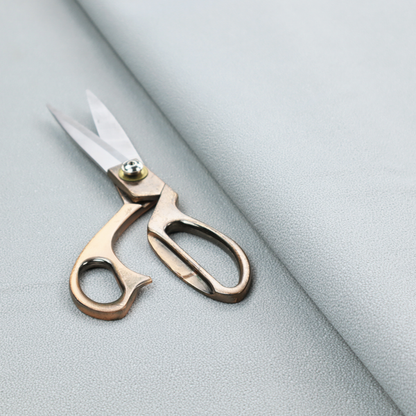 A Merida Suede upholstery fabric in a light grey colour.