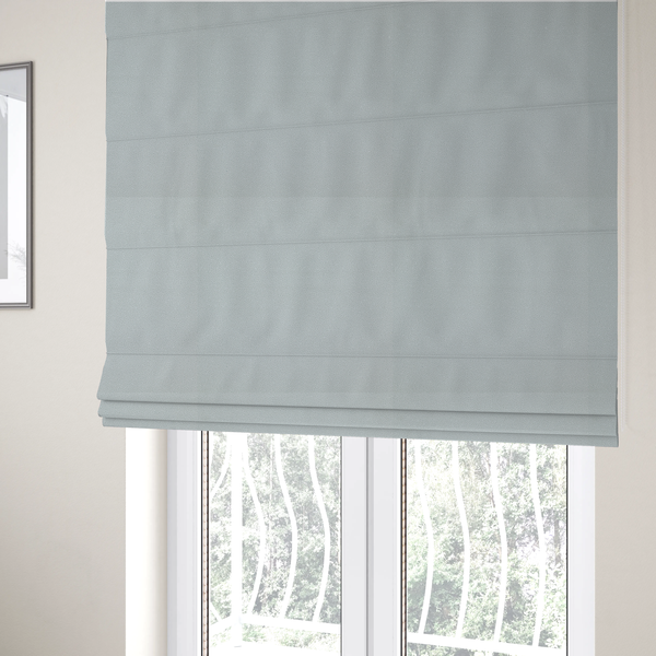 The fabric used to create these Roman blinds is a Merida Suede upholstery fabric in a light grey colour.