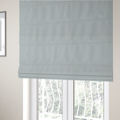 The fabric used to create these Roman blinds is a Merida Suede upholstery fabric in a light grey colour.