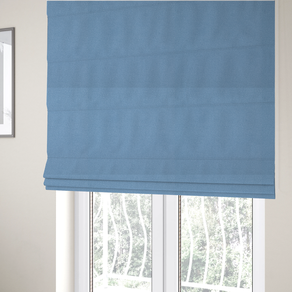 The fabric used to create these Roman blinds is a Merida Suede upholstery fabric in a soft, medium sky blue colour.