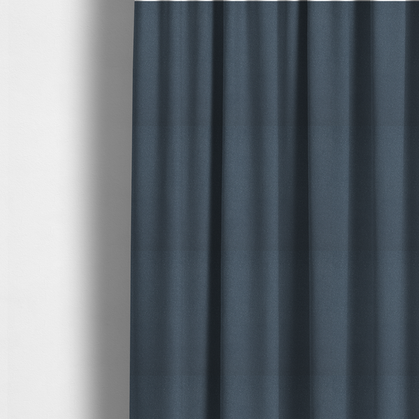 The fabric used to create these made-to-measure curtains is a Merida Suede upholstery fabric in a muted slate blue or denim blue colour.