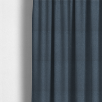 The fabric used to create these made-to-measure curtains is a Merida Suede upholstery fabric in a muted slate blue or denim blue colour.