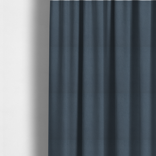 The fabric used to create these made-to-measure curtains is a Merida Suede upholstery fabric in a muted slate blue or denim blue colour.