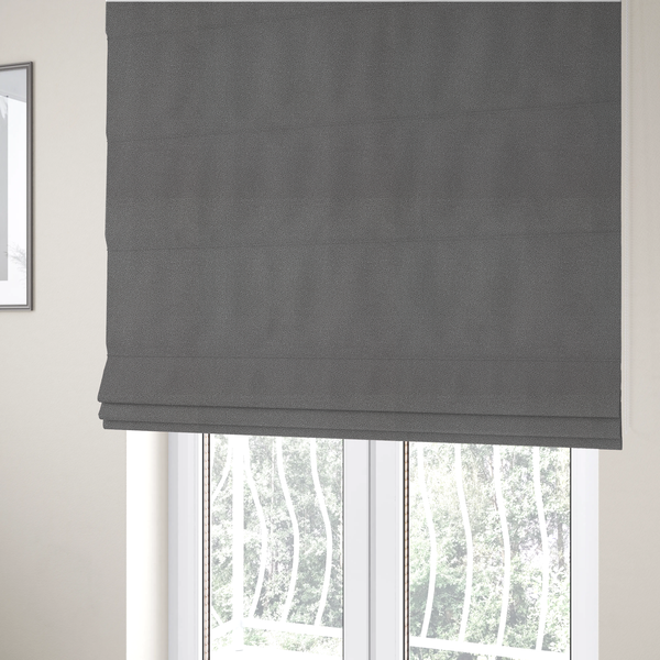 The fabric used to create these Roman blinds is a Merida Suede upholstery fabric in a medium charcoal grey colour.