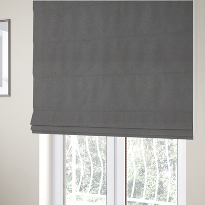 The fabric used to create these Roman blinds is a Merida Suede upholstery fabric in a medium charcoal grey colour.