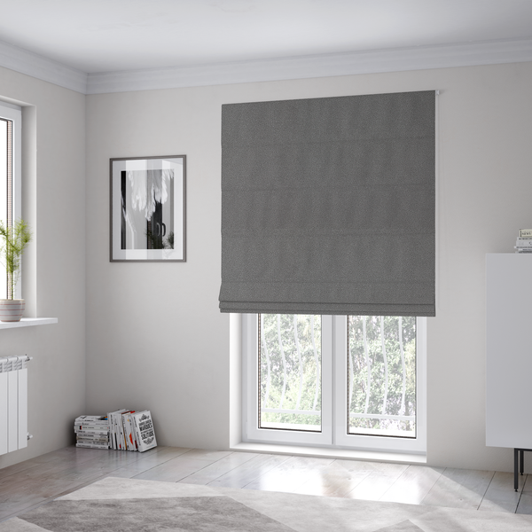 The fabric used to create these Roman blinds is a Merida Suede upholstery fabric in a medium charcoal grey colour.