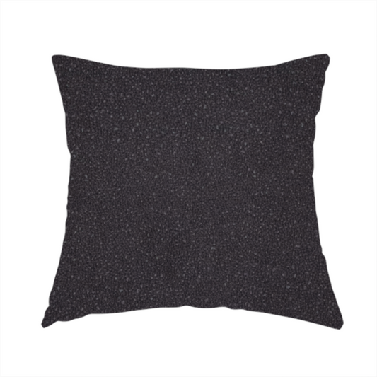 The fabric used to create this handmade cushion is a Merida Suede upholstery fabric in a dark purple or deep plum colour.
