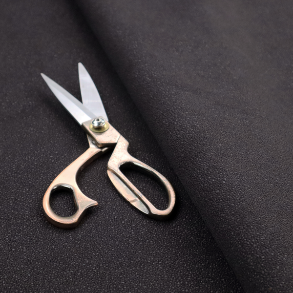 Merida Suede upholstery fabric in a dark purple or deep plum colour.