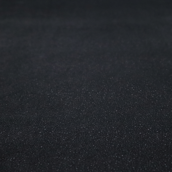 Merida Suede upholstery fabric in a deep charcoal grey or off-black colour.