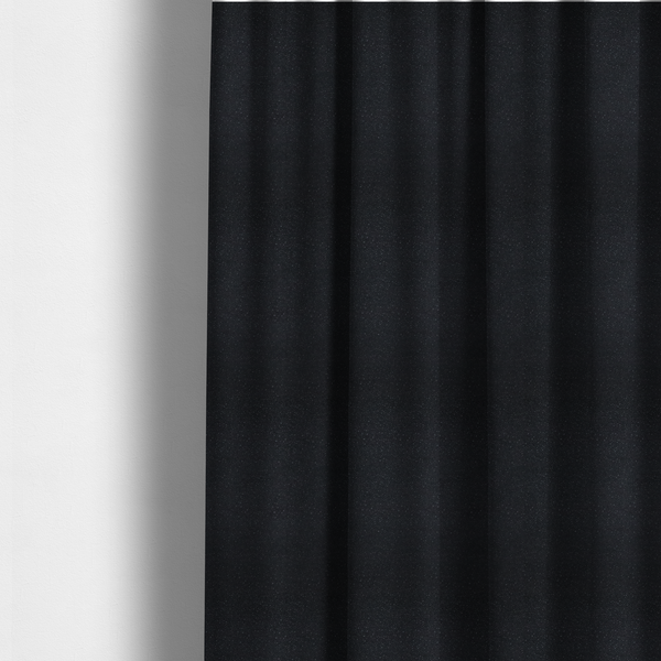 The fabric used to create these made-to-measure curtains is a Merida Suede upholstery fabric in a deep charcoal grey or off-black colour.