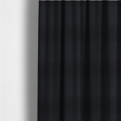 The fabric used to create these made-to-measure curtains is a Merida Suede upholstery fabric in a deep charcoal grey or off-black colour.