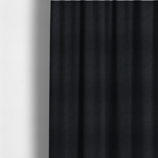 The fabric used to create these made-to-measure curtains is a Merida Suede upholstery fabric in a deep charcoal grey or off-black colour.