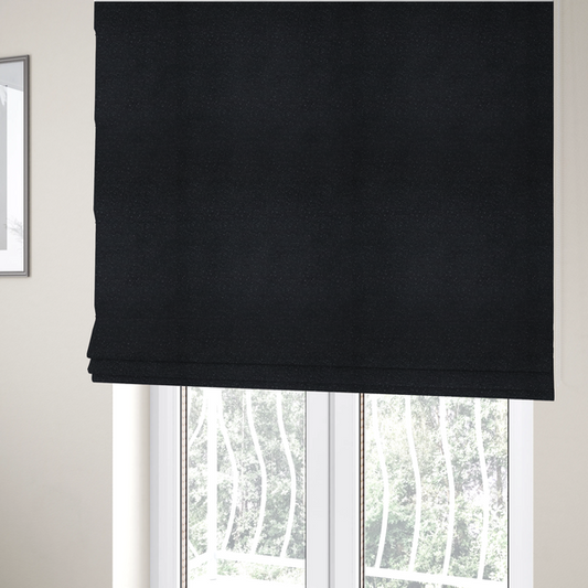 The fabric used to create these Roman blinds is a Merida Suede upholstery fabric in a deep charcoal grey or off-black colour.