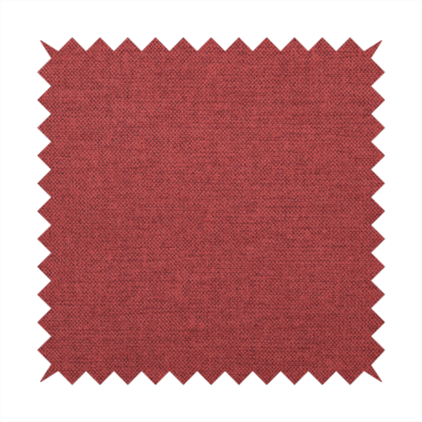 A finely textured weave in a dusty rose or muted red colour. The material features a subtle heathered look with tiny variations of darker and lighter threads throughout.