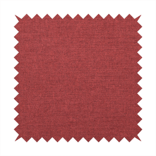 A finely textured weave in a dusty rose or muted red colour. The material features a subtle heathered look with tiny variations of darker and lighter threads throughout.