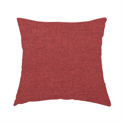 The fabric used to create this handmade cushion is a finely textured weave in a dusty rose or muted red colour. The material features a subtle heathered look with tiny variations of darker and lighter threads throughout.