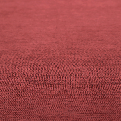 A finely textured weave in a dusty rose or muted red colour. The material features a subtle heathered look with tiny variations of darker and lighter threads throughout.